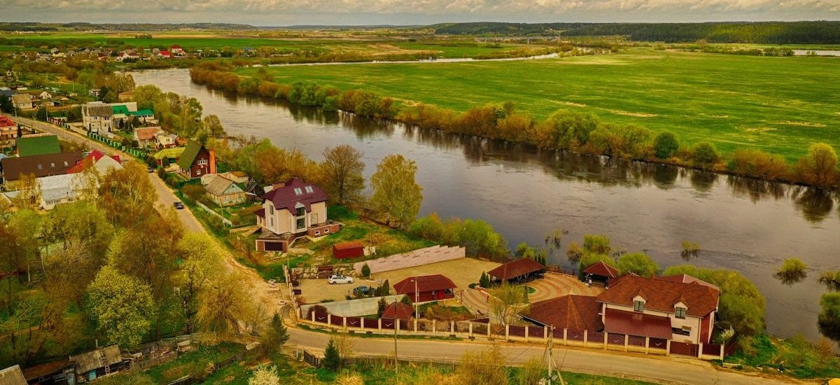 a river with houses and trees