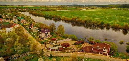a river with houses and trees