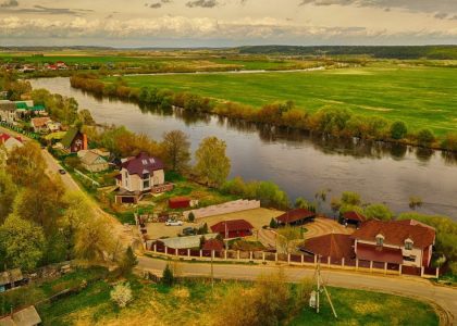 a river with houses and trees